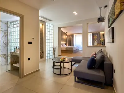 a living room with a couch and a table at Athens City Suites in Athens