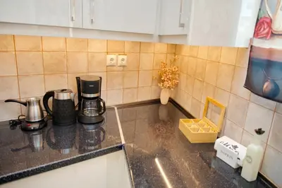 a kitchen counter top with a coffee maker on it at Skyway Comfort Residences in Spáta