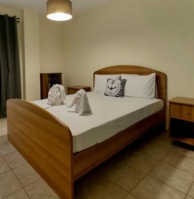 a bedroom with a bed with towels on it at Betty's House in Porto Rafti