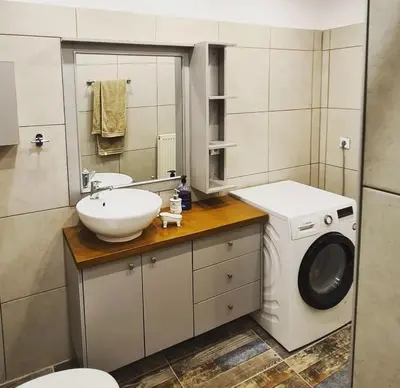 a bathroom with a sink and a washing machine at Betty's House in Porto Rafti