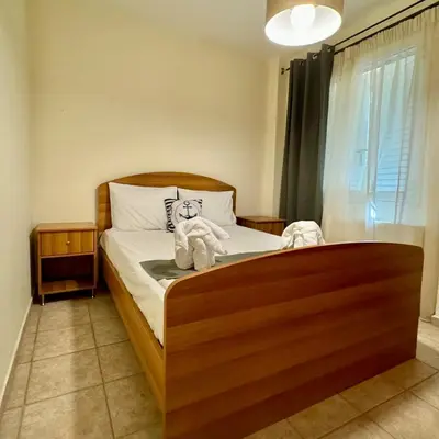 a bedroom with a bed with a teddy bear on it at Betty's House in Porto Rafti
