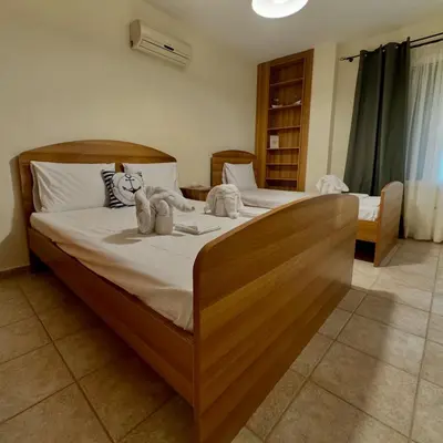 a bedroom with a large bed with towels on it at Betty's House in Porto Rafti