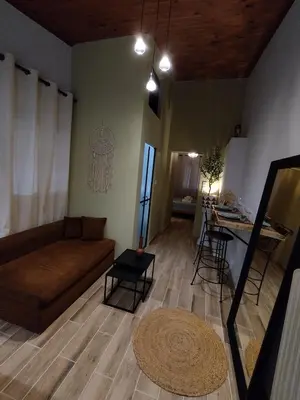 a living room with a couch and a table at Olive apartment in Paianía