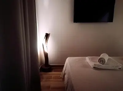 a room with a bed and a light on the wall at Olive apartment in Paianía