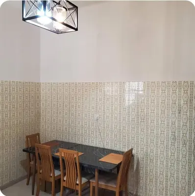 a dining room with a black table and chairs at Home away from home - 3BR - 14' walk to port in Piraeus