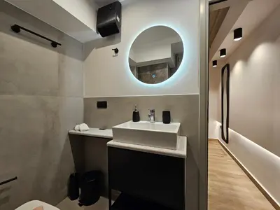a bathroom with a sink and a mirror at Silk Suites by YHA in Athens