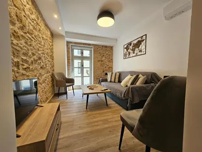 a living room with a couch and a fireplace at Silk Suites by YHA in Athens