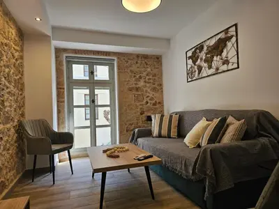 a living room with a couch and a table at Silk Suites by YHA in Athens