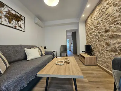 a living room with a couch and a table at Silk Suites by YHA in Athens