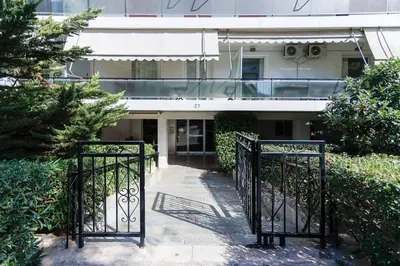 an iron gate in front of a building at Modern 2-Bedroom Apartment in Downtown Glyfada in Athens