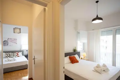 a bedroom with two beds and a window at Elegant 3-Bedroom Retreat in the Heart of Kolonaki in Athens
