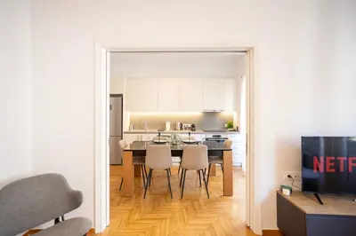 a kitchen and dining room with a table and chairs at Elegant 3-Bedroom Retreat in the Heart of Kolonaki in Athens