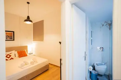 a small bedroom with a bed and a shower at Elegant 3-Bedroom Retreat in the Heart of Kolonaki in Athens