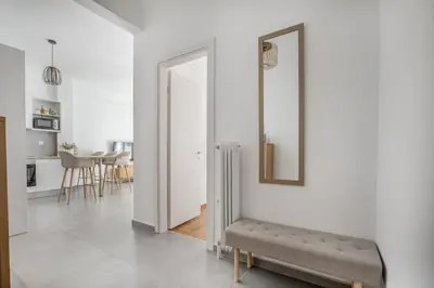 a living room with a bench and a mirror at Selesta - Stylish 2 Bedroom Apartment in Athens in Athens