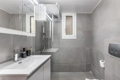 a bathroom with a sink and a mirror at Selesta - Stylish 2 Bedroom Apartment in Athens in Athens