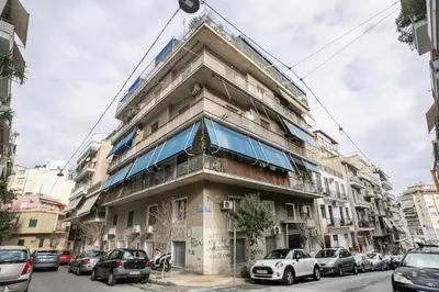 a tall building with cars parked in front of it at Selesta - Stylish 2 Bedroom Apartment in Athens in Athens