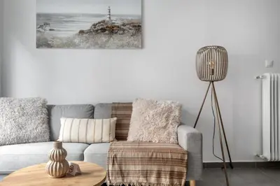 a living room with a gray couch and a table at Selesta - Stylish 2 Bedroom Apartment in Athens in Athens