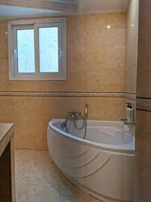 a bath tub in a bathroom with a window at Temple of Zeus 3BD Apartment in Athens