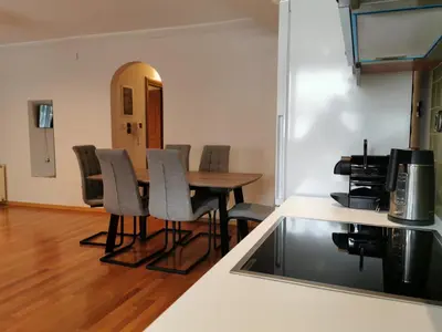 a kitchen with a table and chairs in a room at Temple of Zeus 3BD Apartment in Athens