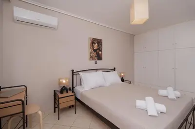 a bedroom with a bed with two white pillows on it at Terminal Square Suites in Markopoulo