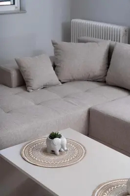 a living room with a couch and a plant on a table at Terminal Square Suites in Markopoulo