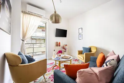 a living room with a couch and chairs and a table at Modern 2BR Apartment with Balcony Near Metro in Athens