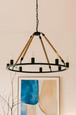 a chandelier hanging over a table with a picture at Villa Calma by A&D Properties in Porto Rafti