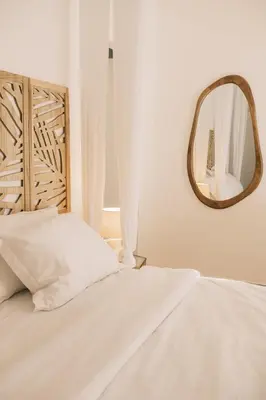 a bedroom with a bed with a mirror on the wall at Villa Calma by A&D Properties in Porto Rafti