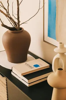 a table with two books and a vase with a plant at Villa Calma by A&D Properties in Porto Rafti
