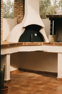 a pizza oven sitting on top of a patio at Villa Calma by A&D Properties in Porto Rafti
