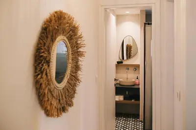 a mirror on a wall in a bathroom with a sink at Villa Calma by A&D Properties in Porto Rafti
