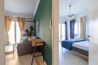 a bedroom with a bed and a desk with a chair at AIOLOS Glyfada LUX Escape suite 6 in Athens