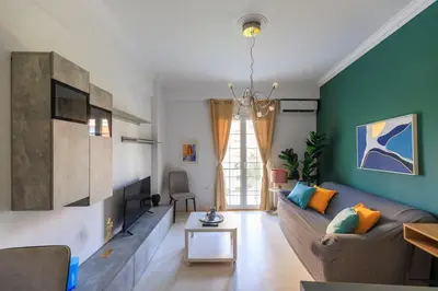 a living room with a couch and a table at AIOLOS Glyfada LUX Escape suite 6 in Athens