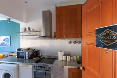 a kitchen with a stove and a microwave at AIOLOS Glyfada LUX Escape suite 6 in Athens