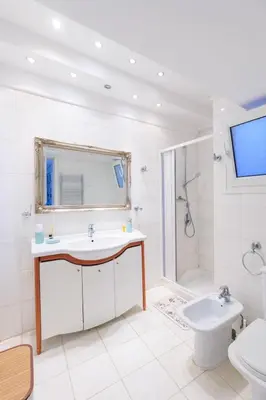a bathroom with a sink and a shower and a toilet at AIOLOS Glyfada LUX Escape suite 6 in Athens