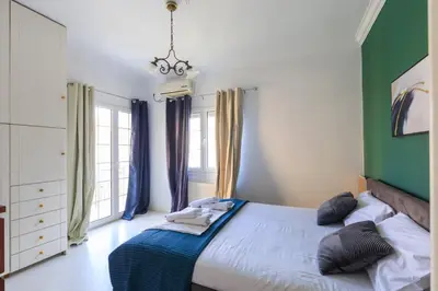a bedroom with a large bed with a green wall at AIOLOS Glyfada LUX Escape suite 6 in Athens
