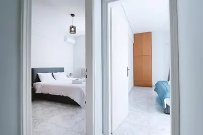 a bedroom with a bed and a room with a mirror at The Sunrise Apartment By Athens Airport 1 in Spáta