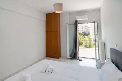 a bedroom with a white bed and a window at The Sunrise Apartment By Athens Airport 1 in Spáta