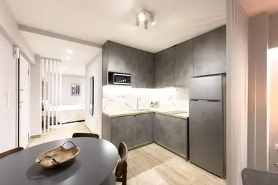 a kitchen with a table and a refrigerator at Classy Athens Retreat near Downtown in Athens