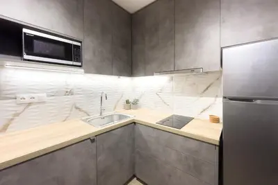 a kitchen with a sink and a microwave at Classy Athens Retreat near Downtown in Athens