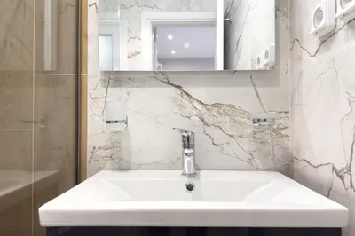 a bathroom with a white sink and a mirror at Classy Athens Retreat near Downtown in Athens