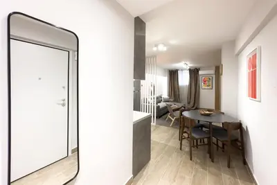 a living room with a mirror and a table at Classy Athens Retreat near Downtown in Athens