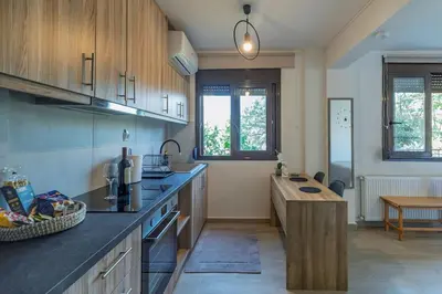 a kitchen with a counter and a table in it at New, Comfy, Spotless Studio in Ilioupoli, Athens in Athens