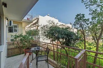 a balcony with two chairs and a table at New, Comfy, Spotless Studio in Ilioupoli, Athens in Athens