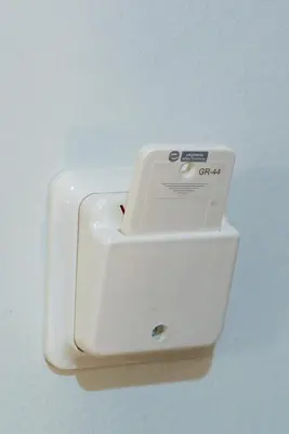 a white soap dispenser hanging on a wall at New, Comfy, Spotless Studio in Ilioupoli, Athens in Athens