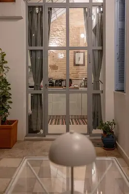a chair in a room with a large window at Athenian Cypress House, Atelier in Athens
