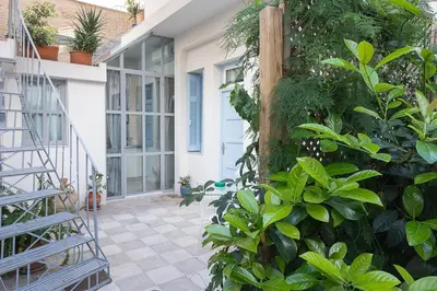 a porch of a house with green plants at Athenian Cypress House, Studio in Athens
