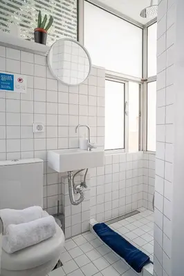 a white bathroom with a sink and a toilet at Athenian Cypress House, Studio in Athens