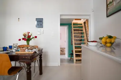 a kitchen with a table and a dining room at Athenian Cypress House, Maisonette in Athens