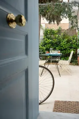 a door with a bike parked next to a table at Athenian Cypress House, Maisonette in Athens